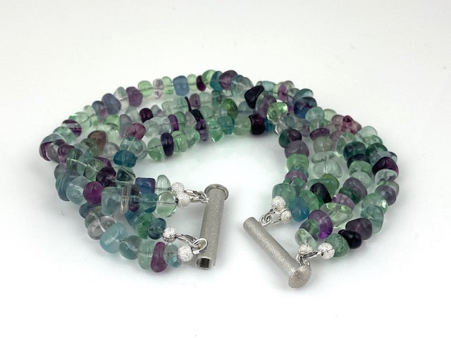 Four strands of multi-color fluorite nuggests witha silver magnetic bar clasp made by EAT Gallery!