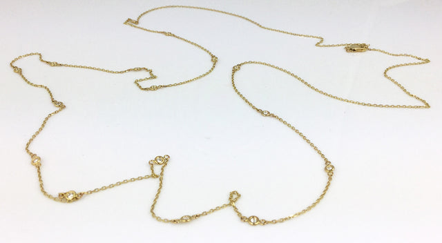 Great on its own or as a layering piece, this simple yet elegant necklace is in 14k yellow gold and features 0.5ctw bezel set white diamonds.  The total length is 36"