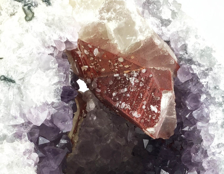 Planed violet grey quartz with russet calcite spikes