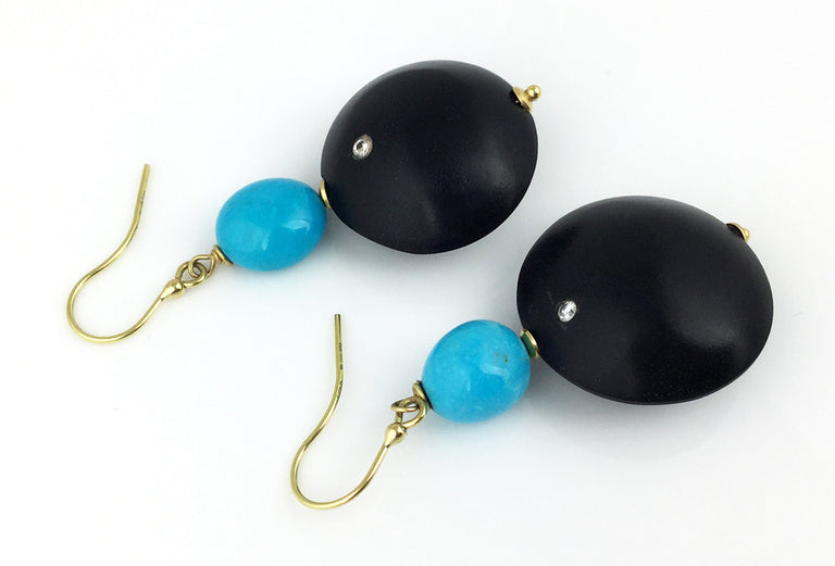 Sleeping beauty turquoise takes center stage in these 18k yellow gold earrings with ebony and diamonds.  