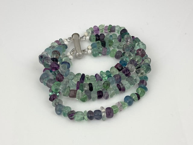 Four strands of multi-color fluorite nuggests witha  silver magnetic bar clasp made by EAT Gallery!