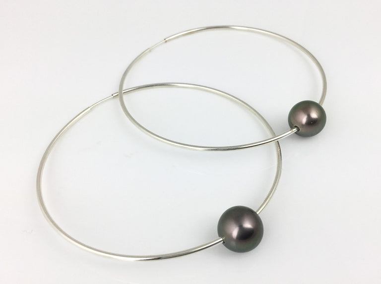 Fun & always in style these sterling silver hoops are 2 1/4 inches in diameter and feature two beautiful Tahitian pearls!  